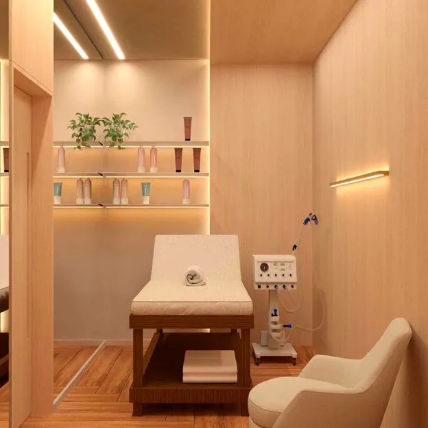 Sala com maca, poltrona e aparelho de tecnologia estética